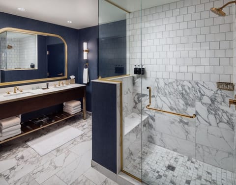 En suite bathroom with a deep soaking tub and enclosed glass shower.