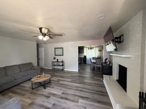 Living room showing coffee table and newer fan