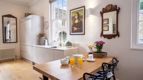 The dining area is tucked beside the kitchen units with a bench and chairs to seat four.