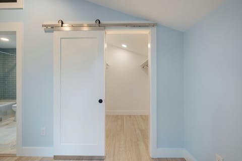Large walk-in closet in upstairs bedroom (door to bathroom on the left of photo)
