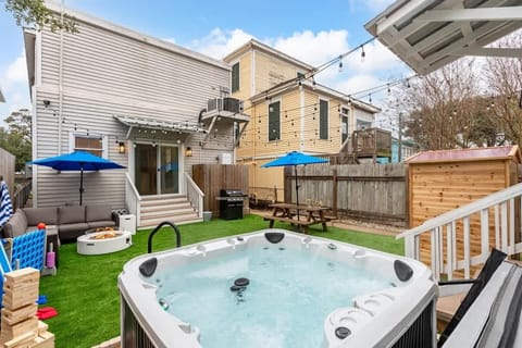 Outdoor Paradise: Dive into fun with a hot tub, fire pit, and shaded lounging for ultimate relaxation!