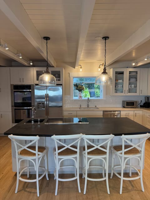 Kitchen island with induction stovetop and countertop seating for 4