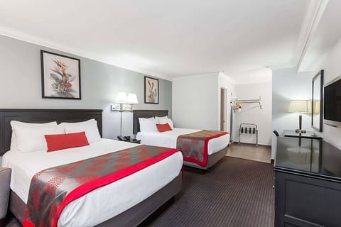 Recharge in a modern room with sofa, desk, and big TV.