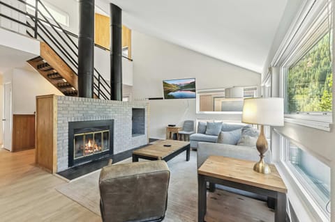 Living room 1: Main floor, wood-burning fireplace, Smart TV, deck access