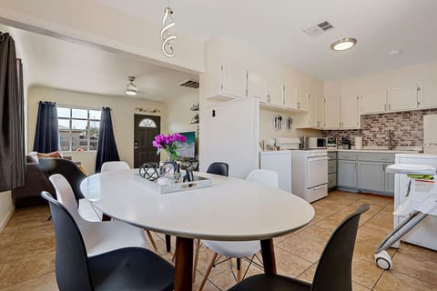 Small dining table with chairs and open Kitchen