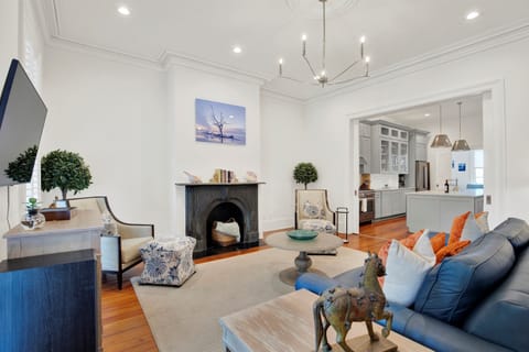 Gracious parlor with floor-to-ceiling windows + heart pine floors.