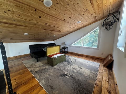 Loft area with a repurposed military trunk for storage
