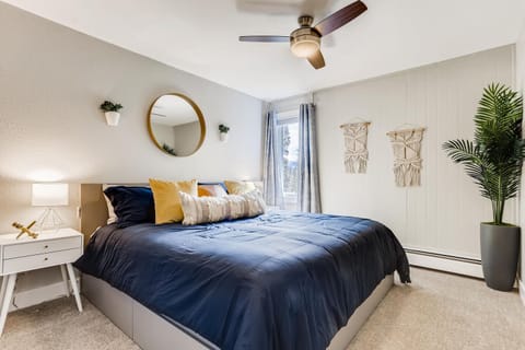 Bedroom with king bed, ceiling fan, closet