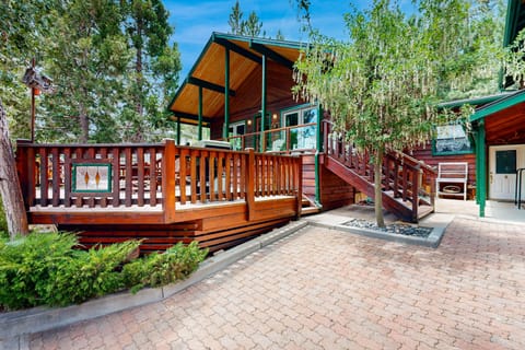 Private outdoor deck with comfortable seating, BBQ grill, surrounded by tall pines, perfect for relaxing under the trees after a day of adventure—enjoy peaceful forest views, fresh air, and a truly rejuvenating stay.
