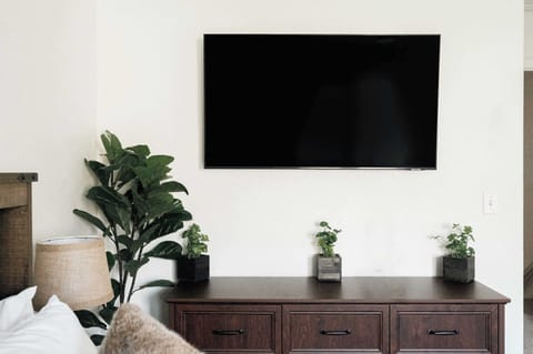 Primary bedroom with smart TV plus a full, private ensuite bathroom