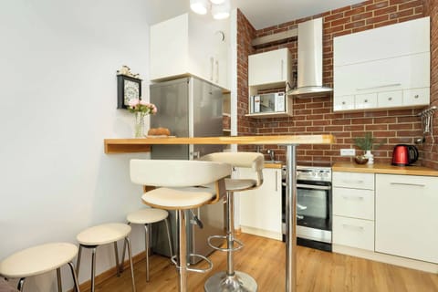 A small dining corner with a round table and two chairs, situated next to the kitchen in a compact layout.