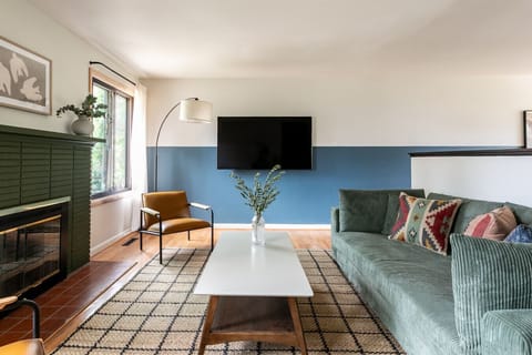 Bright and welcoming space with cozy seating and a Roku TV. Perfect for relaxing or streaming your favorite shows.