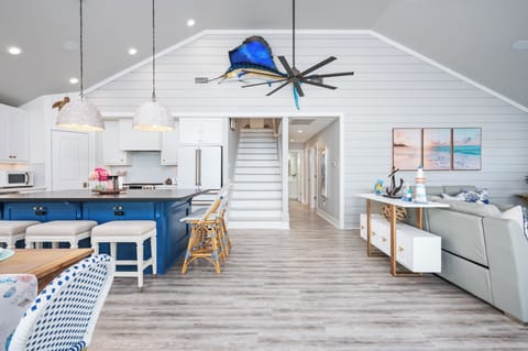 Bright coastal kitchen with island seating and open layout.