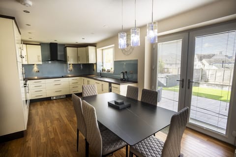 The open-plan kitchen and dining space is perfect for entertaining, or spending time together at mealtimes.