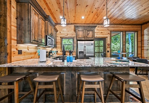 A cook’s dream kitchen with modern appliances, beautiful finishes, and room for everyone to gather around.