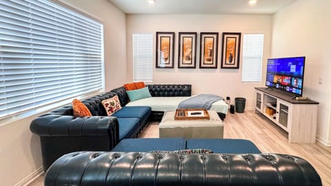 Living Room 1 – leather L-shaped sofa with 55” Smart TV