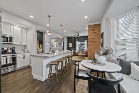 Modern kitchen with stainless steel appliances and granite countertops   - Spacious island seating ideal for meals or conversation   - Open layout connects kitchen to living and dining areas