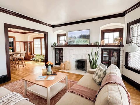 Comfy sectional sofa with a 55” TV, faux fireplace and original 100 years old built-in cabinets.