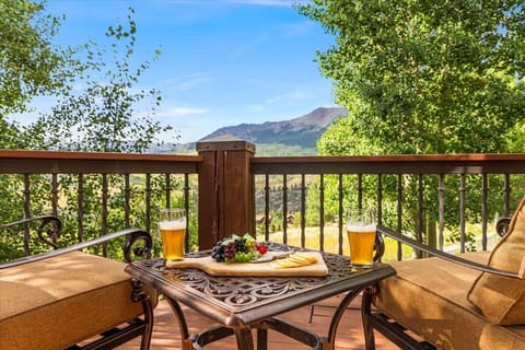 Deck: Outdoor seating for two, mountain views, scenic setting for drinks and snacks
