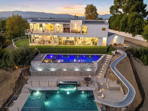 Luxury living redefined: cascading pools, exhilarating slide, and stunning views.