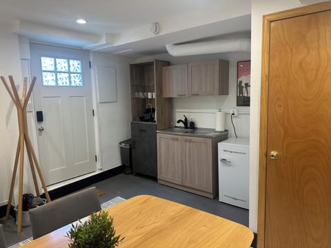 Entry room with bar sink, mini-fridge, Nespresso camera and pods.