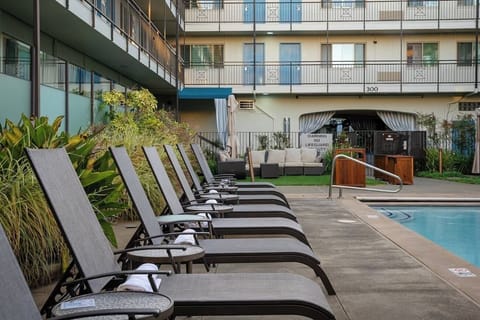 Stretch out poolside with a quiet, resort-style lounger row.