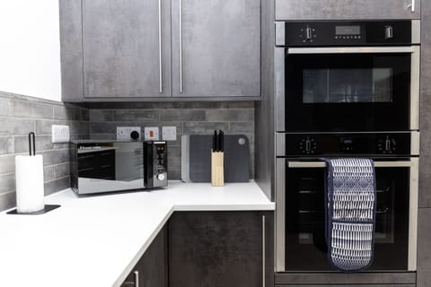 Fully Equipped Kitchen - Brand-new integrated appliances including double oven, microwave and dishwasher. Everything you need for a true home-from-home stay