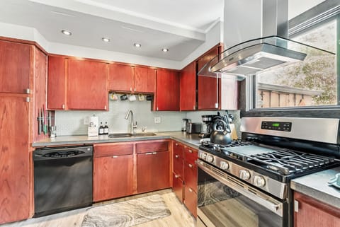 Kitchen: Main floor, drip coffee maker, toaster, kettle, cooking utensils, tableware