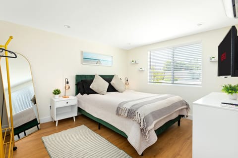 Bright private bedroom with queen bed and natural light