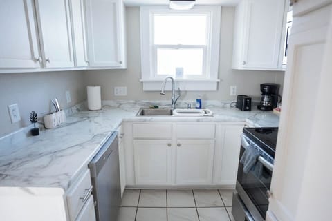 The kitchen is stocked with all the essentials—fridge, stove, oven, microwave, dishwasher, coffee maker, and blender. Whether you're making a full meal or just a quick cup of coffee, you’ll have everything you need.