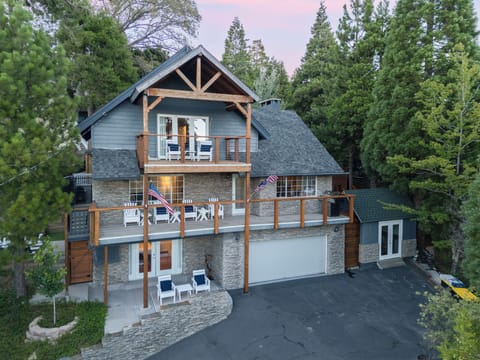 Exterior view of the multi-level home surrounded by trees.