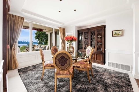 Brunch-ready nook - sunlight streams through arched windows onto your floral centerpiece, with display cabinets for curated collections.