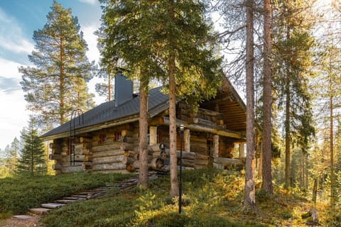 Escape to this traditional, sun-drenched log cabin nestled on a wooded hill, offering an authentic and peaceful Finnish wilderness retreat.