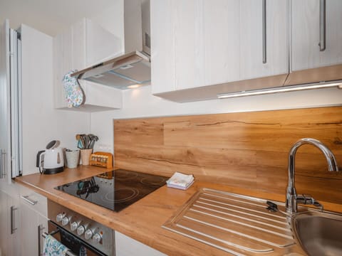 Countertop, Kitchen, Kitchen Appliance, Wood, Flooring, Interior Design, Cabinetry, Furniture, Home Appliance, Major Appliance