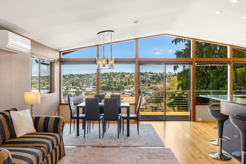 Light-filled living space with large windows and a cozy atmosphere on the main level of the house.
