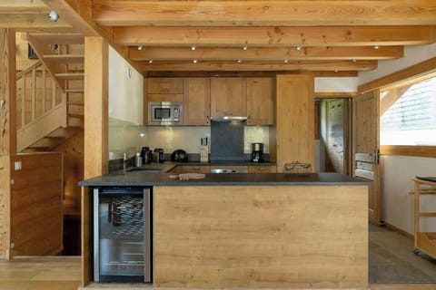 Open plan kitchen with full oven, induction cooking plate, wine fridge, dishswasher, microwave.