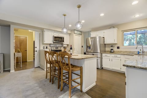 Kitchen island with three barstools — perfect for casual meals or morning coffee.