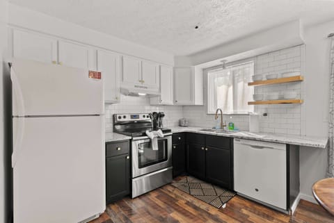 The sleek eat-in kitchen offers ample space & all the comforts of home