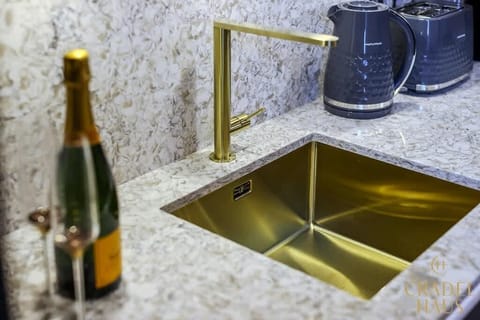 Embrace elegance in Wordsworth's kitchen, boasting granite worktops and luxury brushed brass finishes. With appliances for coffee and tea, but we favor indulging in the bubbly stuff for a touch of celebration.