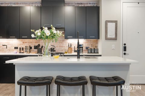 These three plush stools stand by to witness all your coffee theatrics by the gooseneck faucet.
