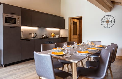 Gather around the large dining table in this bright, open space under vaulted ceilings.