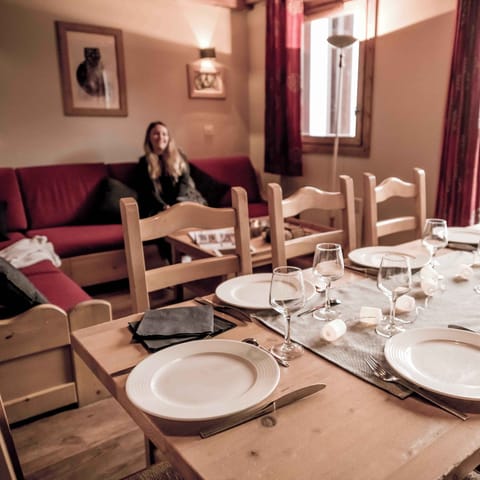 Dining area set for a meal, accented by natural light and warm tones.