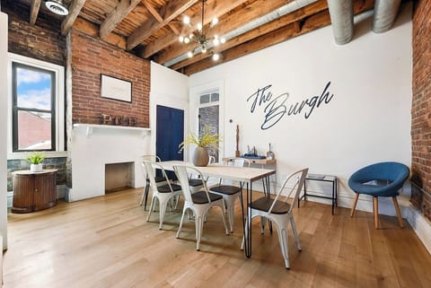 Enjoy a huge dining space with a long table, six chairs, and an extra cushioned seat. The room’s simple yet elegant design creates the perfect ambiance for meals, whether it's a casual breakfast or a special gathering with family and friends.