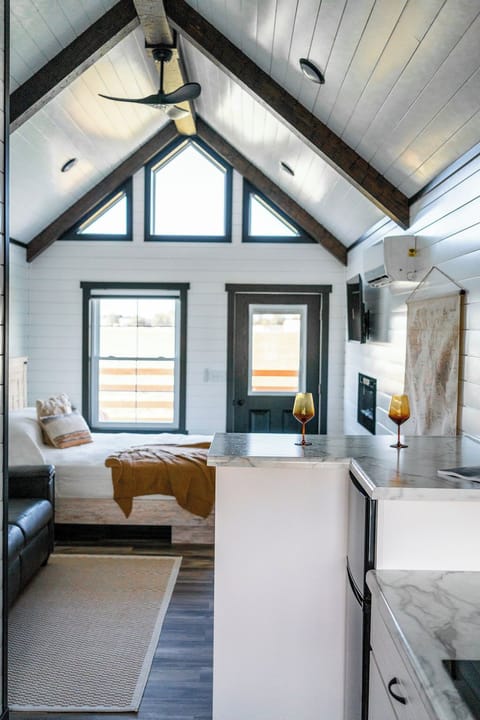 The bedroom has a queen sized bed, electric fireplace, and TV for cozy, restful evenings