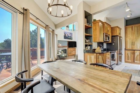 Dining space with sliding doors that open to the deck, bringing in abundant natural light and fresh mountain air..