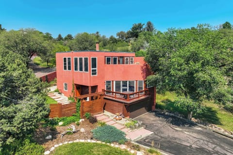Aerial view of the home surrounded by mature trees and landscaping, offering privacy and a beautiful natural setting in Colorado Springs.