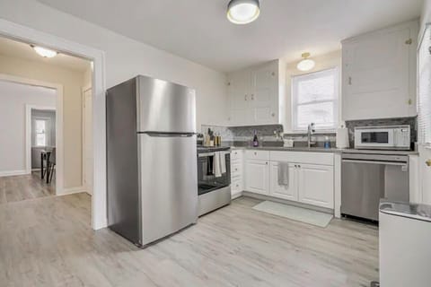 Stainless steel appliances: fridge/freezer, dishwasher, stove, sink