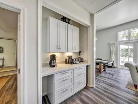 Separate coffee bar with blender, utensils, platters & more for convenience.