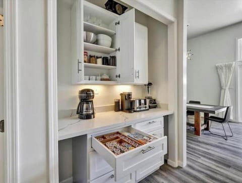 Separate coffee bar with blender, utensils, platters & more for convenience.