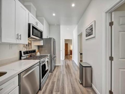 Kitchen with quality appliances, gas stove, dishwasher & rolling prep cart.